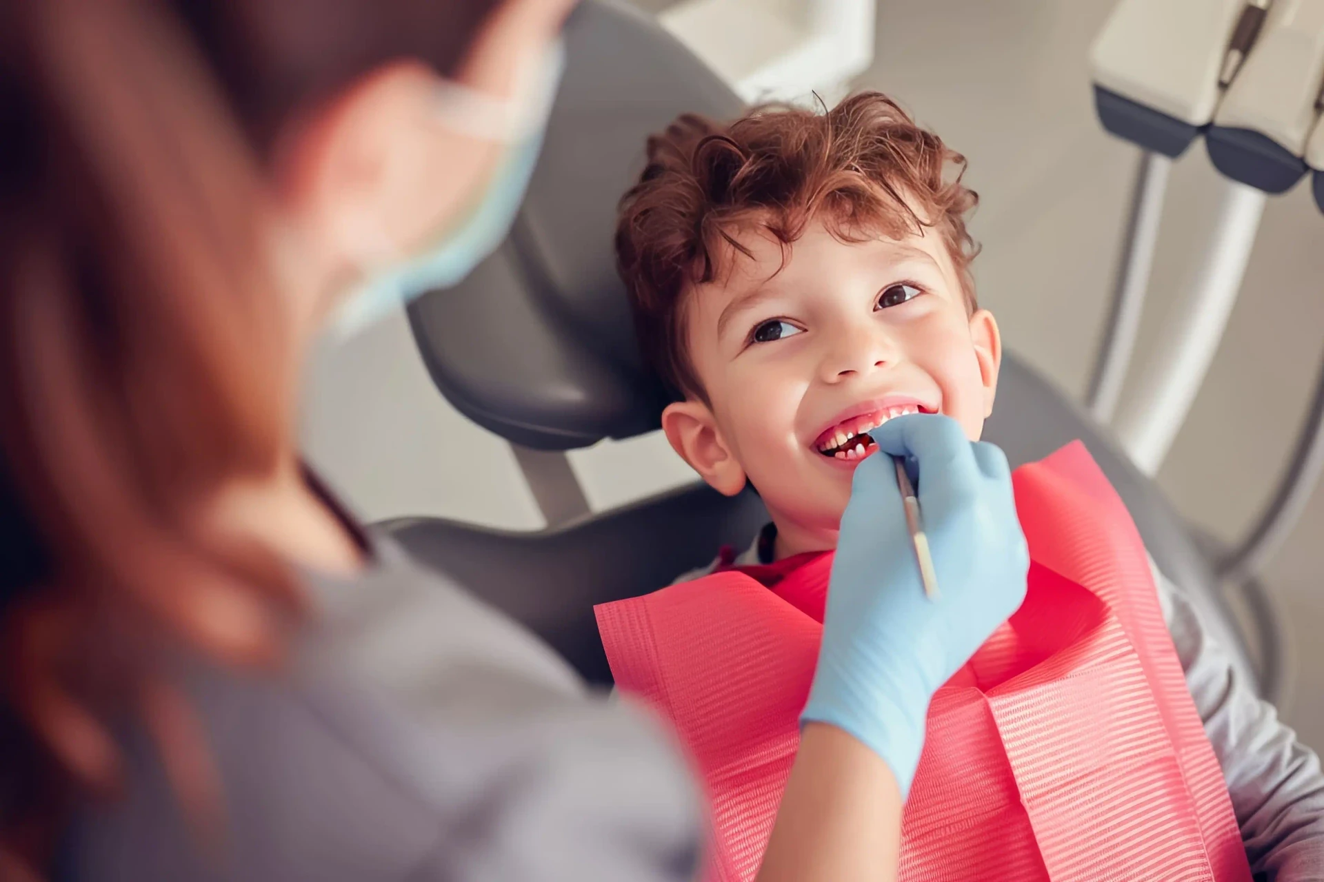 Child receiving a dental examination before pit and fissure sealant treatment